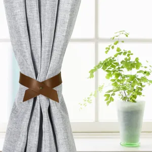 Nordic style brown PU leather curtain tieback, minimalist buckle strap for home decor detail.