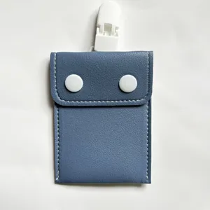 Detailed view of the blue baby pacifier pouch with white clip and snap button design.