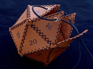 Detailed shot of a brown leather D20 dice bag with dark stitching and black drawstring.