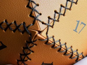 Detail shot of PU leather D20 dice bag showing cross stitching and number print.