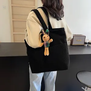 Black corduroy tote bag for women, large capacity casual shoulder bag with cute rabbit pendant.