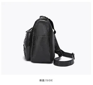 Black soft leather multi-compartment crossbody shoulder bag side detail view display.
