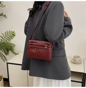 Washed soft leather crossbody bag for women, versatile multi-pocket casual shoulder bag.