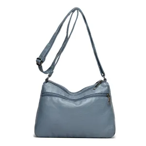 Borsa a tracolla alla moda da donna in pelle lavata morbida blu con molteplici cerniere.