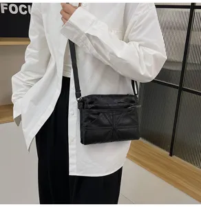 Detail view of the black soft leather women crossbody bag with multi zipper pockets.