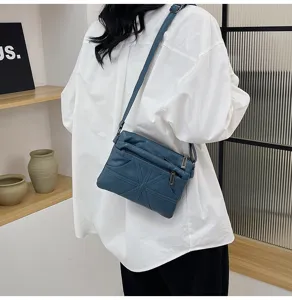 Detail shot of the blue washed soft leather crossbody bag showcasing practical multi-pockets.