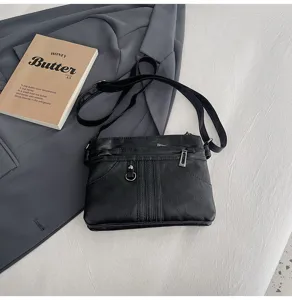 Black soft leather crossbody bag with multi-zippers and adjustable strap for women daily use.
