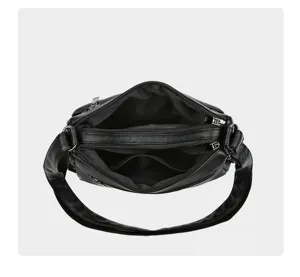 Black soft leather multi-compartment shoulder bag, top view detail showing inner structure.