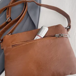 Brown soft leather crossbody shoulder bag for women, casual daily phone purse with zipper.