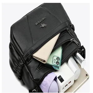 Detail shot of black soft leather multi-compartment women shoulder bag, large capacity design.