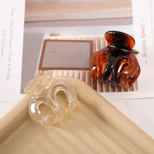 Transparent and tortoise shell hair claw clips, durable resin shark clips for secure hairstyles.