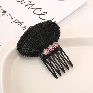 Close-up detail of the black mesh hair bump pad with pink rhinestone flower comb for volume.