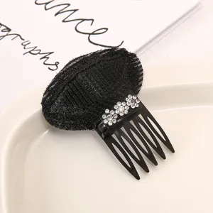 Detailed view of black hair volume bump pad, featuring sparkling rhinestone flowers and comb teeth.