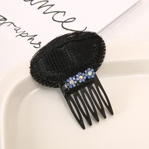Close up view of the hair volume insert detail, showing rhinestone flower and black comb teeth.