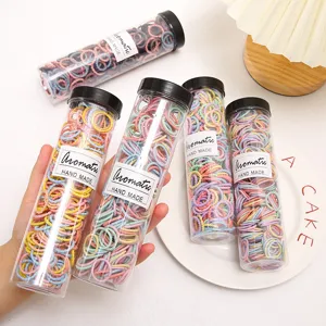 Colorful kids hair ties in clear tube packaging, gentle elastic rubber bands for daily use.