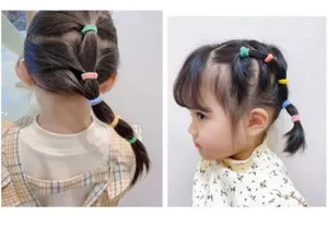 Detailed shot of colorful mini hair rubber bands styled on a child's braided hair neatly.