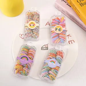 Colorful mini hair ties for kids with clear storage boxes. Cute elastic hair bands styling accessories.