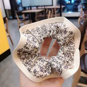 Chic floral print fabric hair scrunchie with structured support rim for daily styling.