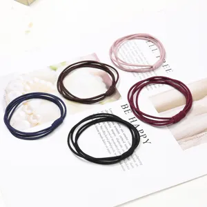 Vista dettagliata di elastici per capelli in vari colori, design morbido per uso quotidiano.