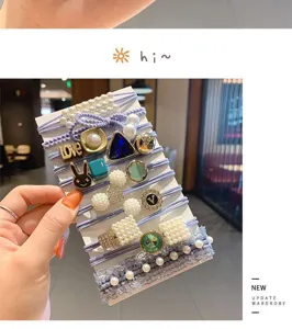 Close-up detail of Korean style pearl and rhinestone hair tie set with purple elastic bands.