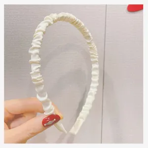 White satin pleated headband close up detail, elegant hair accessory for women daily