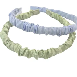 Satin ruffled headband for women, stylish cute hair hoop in light blue and green colors.