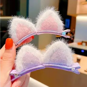 Close-up of cute plush cat ear hair clips, fluffy texture and secure clip details.