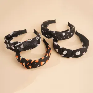 Halloween knotted headband set with ghost and spiderweb prints, chic fabric hair accessories.