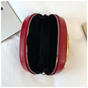 Detail view of the red round leather crossbody bag interior structure and zipper closure.