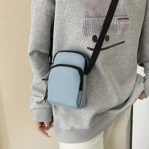 Light blue small crossbody shoulder bag with zipper, compact and stylish phone coin pouch.