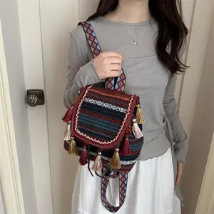Ethnic tassel backpack detail view, featuring colorful geometric diamond print and boho style straps.