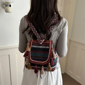 Detailed back view of a retro ethnic style backpack with colorful tassels and diamond patterns.
