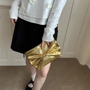 Gold metallic bow clutch bag for women, elegant evening party handbag with stylish design details.