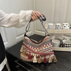 Boho ethnic style tassel shoulder bag for women, casual stripe pattern fabric handbag.