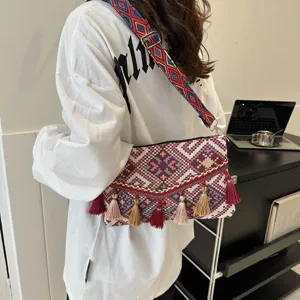 Ethnic style tassel crossbody bag for women, bohemian envelope shoulder bag with geometric strap.