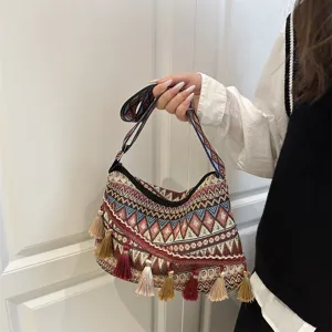 Ethnic style woven shoulder bag with chic tassels and geometric pattern for daily casual wear.
