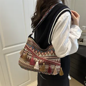 Bohemian ethnic style shoulder bag with geometric woven patterns and playful colorful tassels.