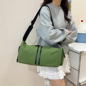 Detail view of the casual green nylon crossbody bag, showing its durable fabric and strap.