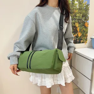 Casual green canvas crossbody shoulder bag detail showcasing the spacious design and wide strap.