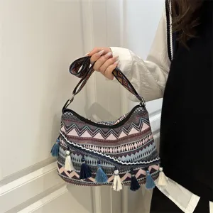 Boho ethnic style striped tassel handbag for women, casual shoulder bag detail view.