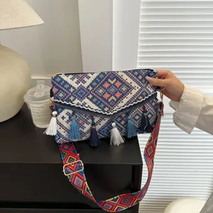 Ethnic style women crossbody bag with colorful woven geometric pattern and cute tassels.