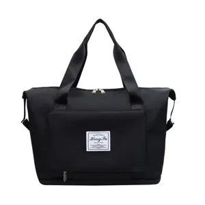 Large capacity foldable travel duffel bag detail view, black portable fitness luggage bag.