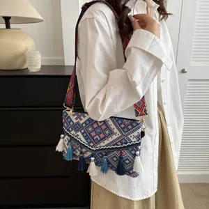 Detail view of women's ethnic style tassel crossbody bag with geometric pattern and bohemian charm.