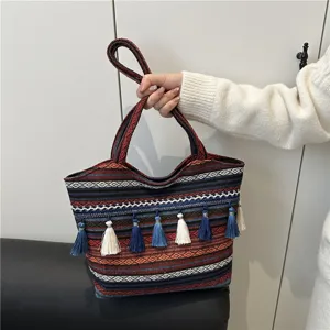 Ethnic woven tote bag with colorful tassels, large capacity and stylish design.