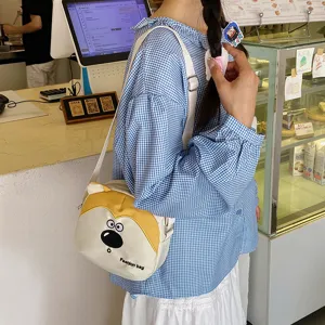 Cute cartoon dog print canvas crossbody bag for kids, casual shoulder bag for daily outdoor play.