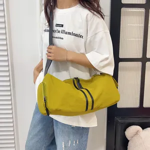 Detail view of the casual yellow crossbody duffel bag, showing large capacity and daily style.