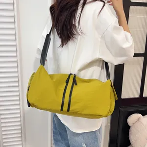 Casual yellow shoulder duffel bag for women, large capacity travel crossbody bag with black straps.