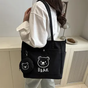 Canvas shoulder tote bag detail view showing cute bear print and matching mini pouch