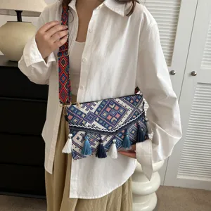 Ethnic style women woven crossbody bag with colorful geometric patterns and cute tassels.