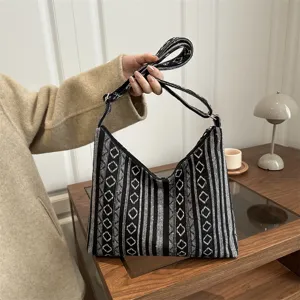 Ethnic style black and white woven pattern shoulder bag detail showing unique design.